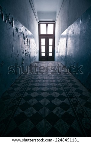 Dark empty hallway corridor in an old abandoned 19th century house with interior in modern style with light in the end.