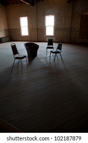 Dark empty room with two windows with chairs