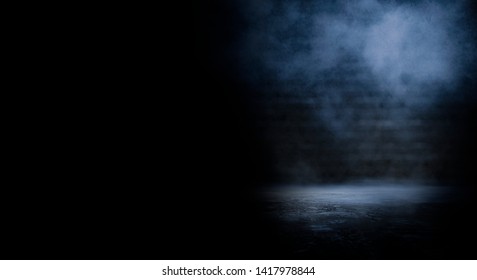 Dark empty scene, blue neon searchlight light, wet asphalt, smoke, night view, rays. Empty black studio room. Dark background. Abstract dark empty studio room texture.  Product showcase spotlight back