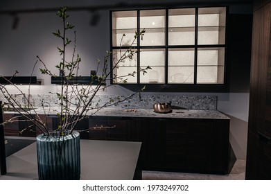 Dark expensive kitchen with built-in appliances. Brown veneer. Pots and pans. - Shutterstock ID 1973249702