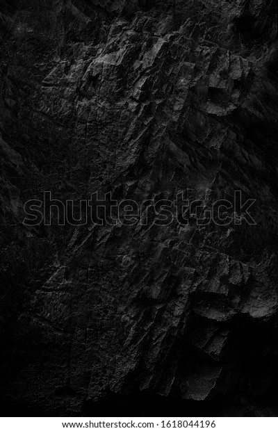 Dark Face Shabby Cliff Face And Divided\
By Huge Cracks And Layers. Coarse, Rough Gray Stone Or Rock Texture\
Of Mountains, Background And Copy Space For Text On Theme Geology\
And Mountaineering.