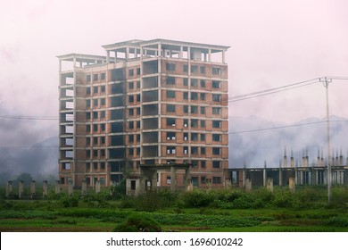 Dark  foggy multi  story abandoned during construction house  unfinished house  Abandoned concrete house as sign economic stagnation  collapse construction company  Building 	recession concept
