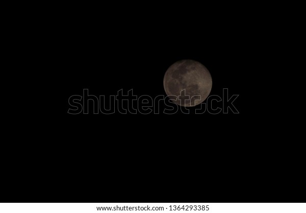 Dark full\
moon with rabbit figure formed by\
craters