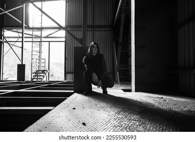 Dark girl in abandoned building, black jacket, black jeans and shoes. Darkness horror and halloween background concept. - Shutterstock ID 2255530593