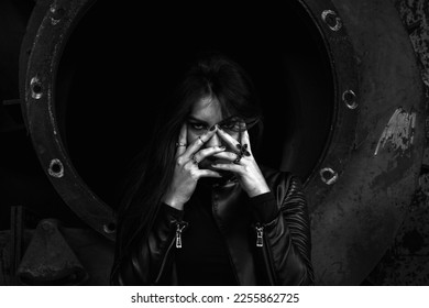 Dark girl in abandoned building, black jacket. Hands over her face. Darkness horror and halloween background concept. - Shutterstock ID 2255862725