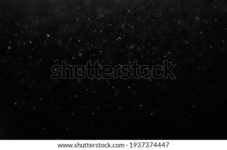 Dark glitter colorful  lights background. light in black background. Dust  in the space. hole in the wall.