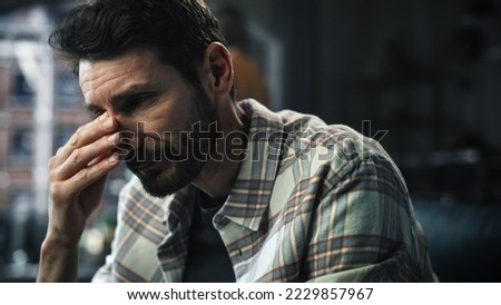 Dark Gloomy Portrait of Fragile Emotional man Crying being Bullied by Partner. Couple Arguing and Fighting Violently. Domestic Violence, Emotional Abuse. Rack Focus with Girfriend Screaming