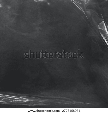 Dark, glossy background with a smooth, reflective texture and subtle light reflections.