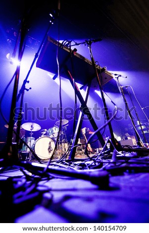Dark and grainy image of a stage ready for a music band live performance