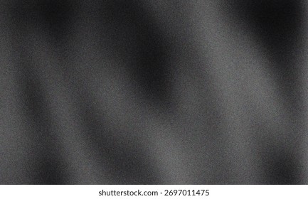 A dark gray background with subtle texture and light gradations across the surface creating an abstract feel for backgrounds and graphic design projects