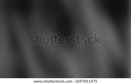 A dark gray background with subtle texture and light gradations across the surface creating an abstract feel for backgrounds and graphic design projects