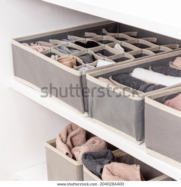 Dark gray\
closet organizers drawer divider. Order in closet. Laundry\
organizers for wardrobe of different\
sizes