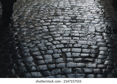 Dark Gray Paving Stones Close-up With Traces Of Slush And Wet Snow. Texture Of Old Stone. Road Surface. Vintage, Grunge.