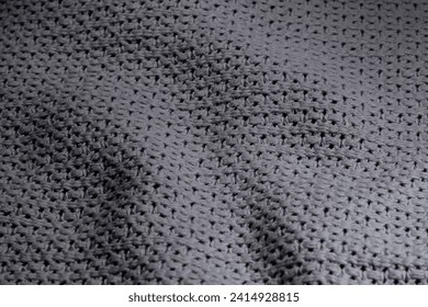 Dark gray textile background, structure of rough, pleated blanket close up
