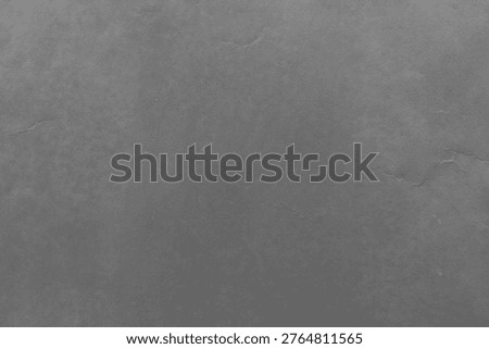 Dark gray textured background with subtle cracks and a smooth, stone-like appearance, creating a rugged and industrial feel.
