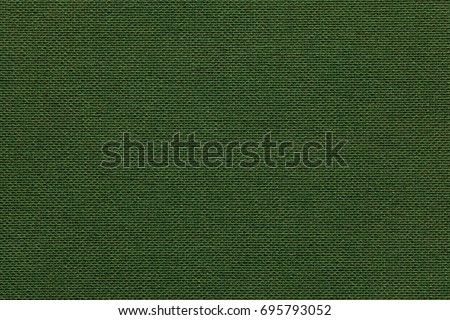 Dark green background from a textile material with wicker pattern, closeup. Structure of the olive fabric with natural texture. Cloth backdrop.