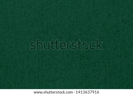 Dark green cardboard or paper texture as background