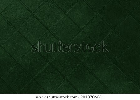 Dark green ceramic tile texture background with diamond diagonal square pattern, grunge surface. Abstract geometric wall backdrop with textured tiles, copy space. Interior element, vintage design
