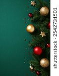 Dark green Christmas background with fir branches, shiny red and gold baubles, stars, and glitter