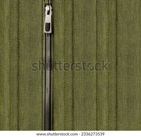 Dark green denim background with zipper. Khaki color denim jeans fabric texture and close zip. Copy space for text