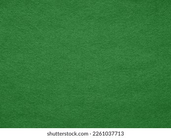 Dark green felt background texture. Surface of snooker, poker, casino. Natural felt background for patchwork, xmas seasonal decoration, lettering or 3d artwork. Full frame retro, vintage pattern.