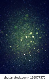 Dark Green Glitter Lights Background. Defocused.