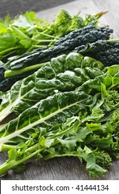 Dark Green Leafy Fresh Vegetables On Cutting Board