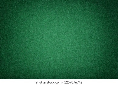 Dark Green Matte Background Of Suede Fabric, Closeup. Velvet Texture Of Seamless Emerald Woolen Felt With Vignette.