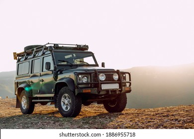 Dark green off-road car in the mountains - Shutterstock ID 1886955718