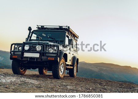 Dark green off-road car in the mountains