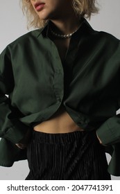 Dark Green Shirt And Black Pleated Pants.