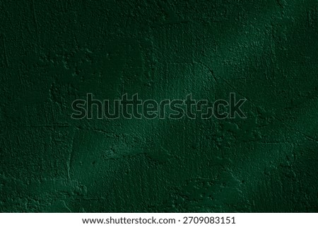 Dark green stucco wall with dramatic light and textured shadow lines