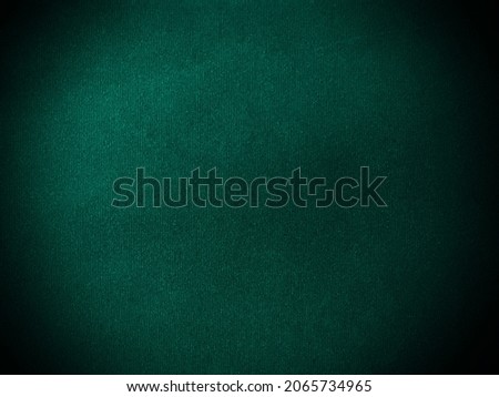 Dark  green velvet fabric texture used as background. Empty green fabric background of soft and smooth textile material. There is space for text.		