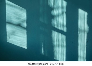 A Dark Green Wall With Beautiful Sun Light And Window Frame Shadow Shine On. Background. Morning Sunlight Shine Through  The Window  On Dark Green Wall Inside The Room.