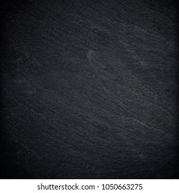 Dark grey black slate background or texture - Shutterstock ID 1050663275