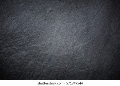 Dark grey and black slate background or texture - Shutterstock ID 571749544