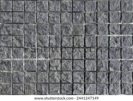 Dark grey or charcoal color square mozaic outdoor paving  texture in checkerboard pattern.