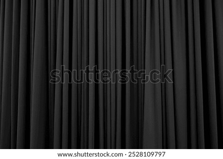 Dark grey curtain with many folds background texture