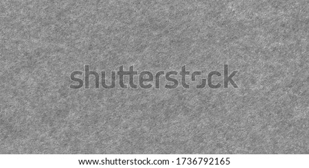 Dark grey felt material. Surface of felted fabric texture abstract background in gray color. High resolution photo.