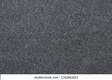 Dark grey granite background used for kitchen worktop, table, window sill, fence. Black and white igneous rock stones texture. Text sign advertising design mockup. Architecture detail natural backdrop