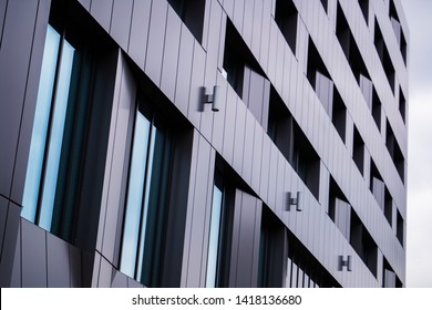 Dark grey metallic panel facad. Modern architectural details. 