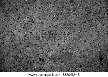 dark grey stone texture with many hole on  like a moon surface