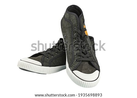 Dark gumshoe, isolated on white background. File contains clipping path. Casual shoes. Lifestyle concept.