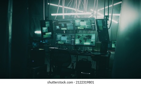 Dark hacker refuge with lamps and tables and computer equipment with programs for cyber crimes and cyber attacks