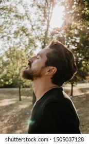 Dark haired man looking and thinking