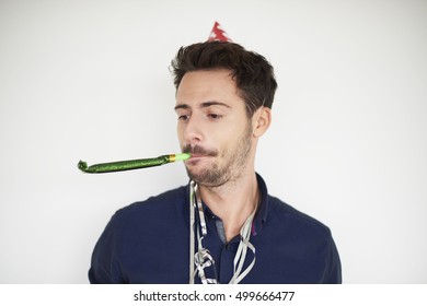 Dark Haired Man With Party Horn Blower