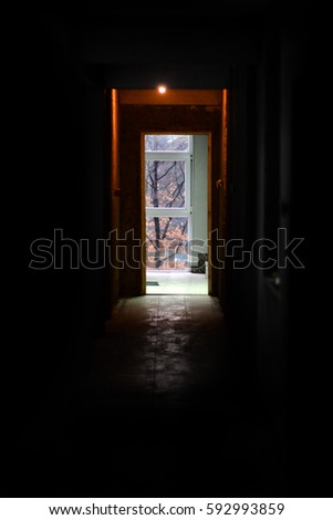 Dark hallway. Diffused light that emanates from the window of a corridor. Exit concept. 