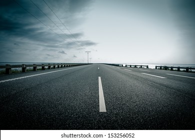 Dark Highway In Cloudy Weather