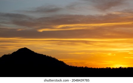 Dark hillside silhouette at sunset - Powered by Shutterstock