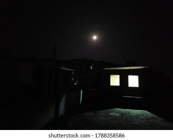 dark house with moon in sky